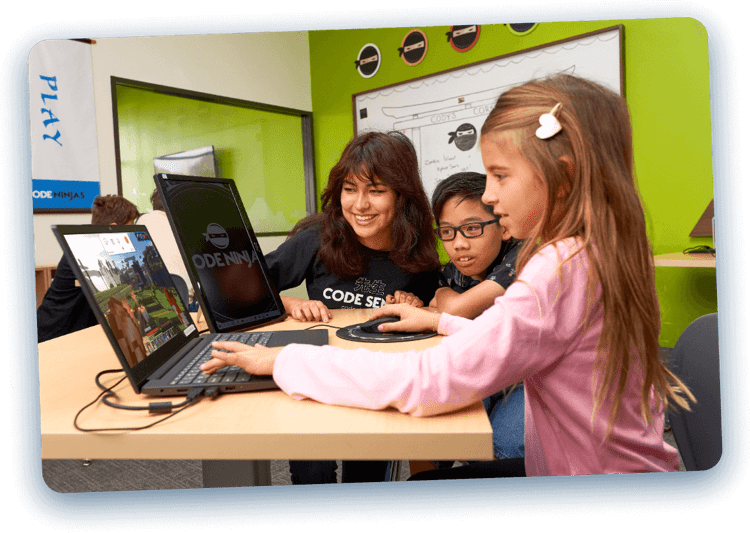 Children playing minecraft on a laptop